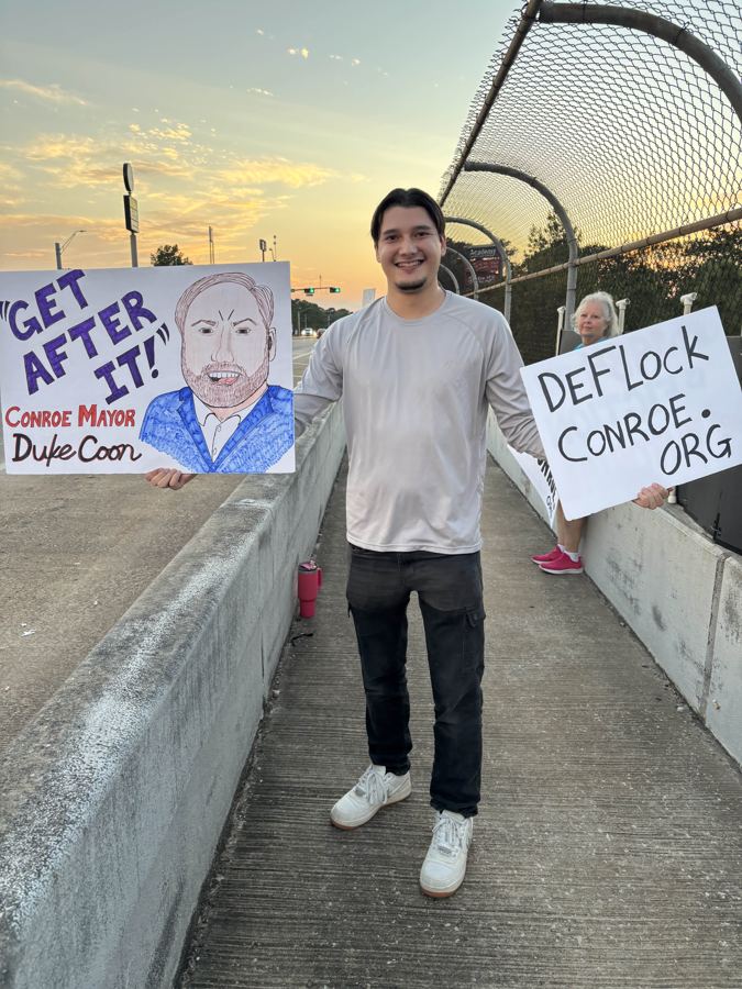 Volunteer holding a DeFlockConroe.org sign next to a Get After It Conroe Mayor Duke Coon sign